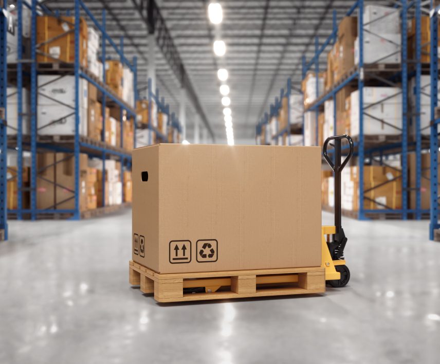 Here's an alt tag for the image: Large cardboard box on pallet jack in warehouse.