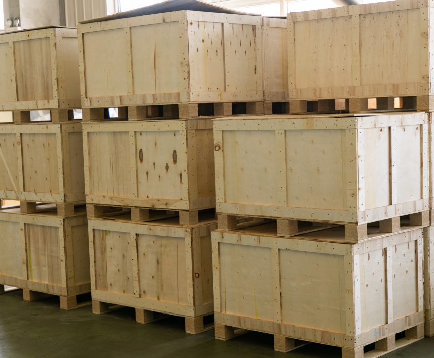 Stacked wooden shipping crates in warehouse.